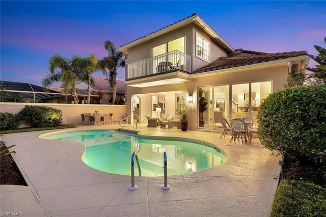a view of a patio with swimming pool table and chairs