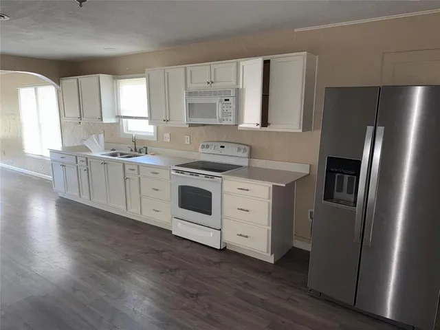 a kitchen with stainless steel appliances a stove a refrigerator and cabinets
