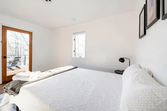 a bedroom with a bed and a large window