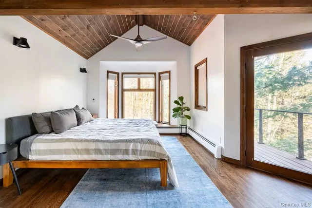 a view of a terrace with wooden bench and trees