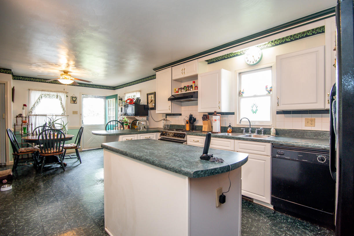 1057 Carroll Road Goodview, VA 24095 - Photo 3 of 46 a kitchen with stainless steel appliances granite countertop a stove a sink and a refrigerator
