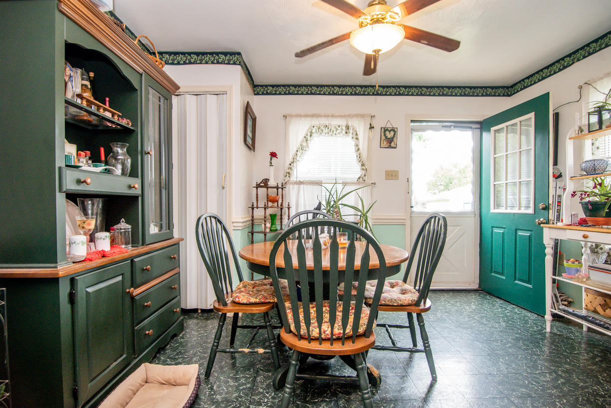 1057 Carroll Road Goodview, VA 24095 - Photo 5 of 46 a dining room with furniture a chandelier and a rug