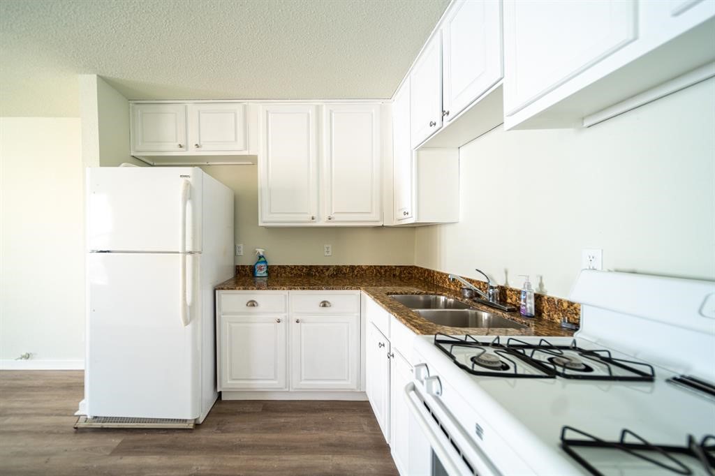 5400 Sheldon Street Houston, TX 77008 - Photo 7 of 18 a kitchen with stainless steel appliances granite countertop a sink stove and refrigerator