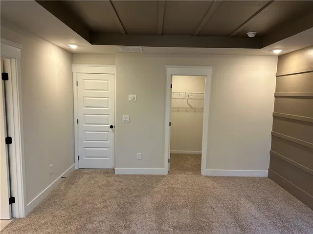 an empty room with closet and mirror