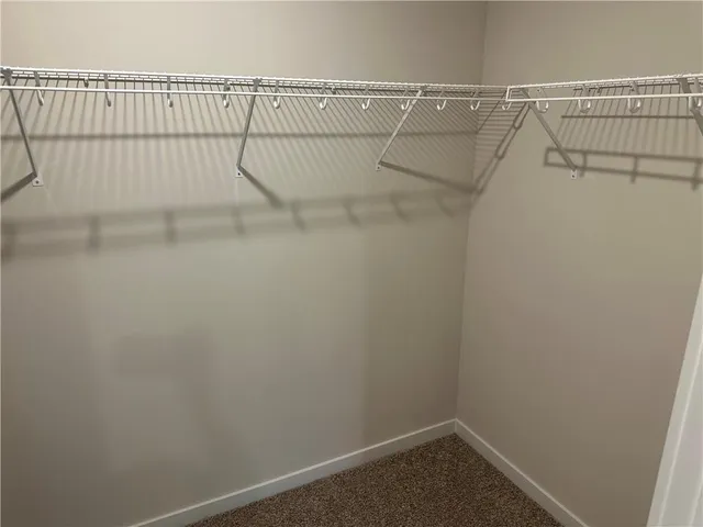 an empty room with closet and mirror