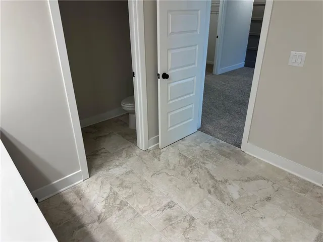 an empty room with closet and a bathroom