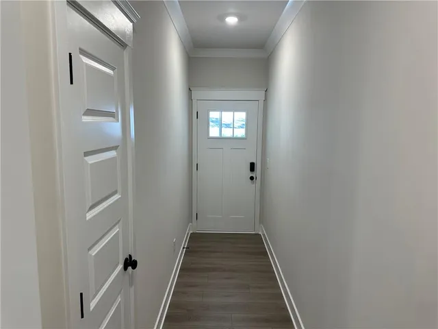 a view of a hallway with wooden floor and entryway