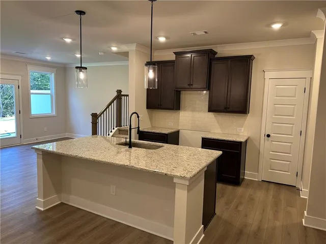 a large kitchen with kitchen island a sink stainless steel appliances and cabinets