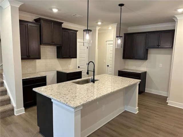 a kitchen with kitchen island a sink stainless steel appliances and counter space