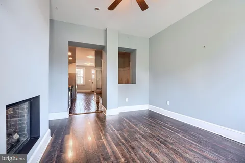 a view of empty room with wooden floor