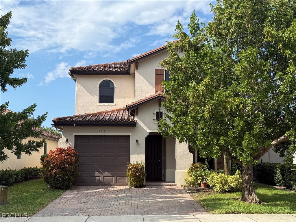 5510 Useppa Drive Ave Maria, FL 34142 - Photo 1 of 20 a front view of a house with garden