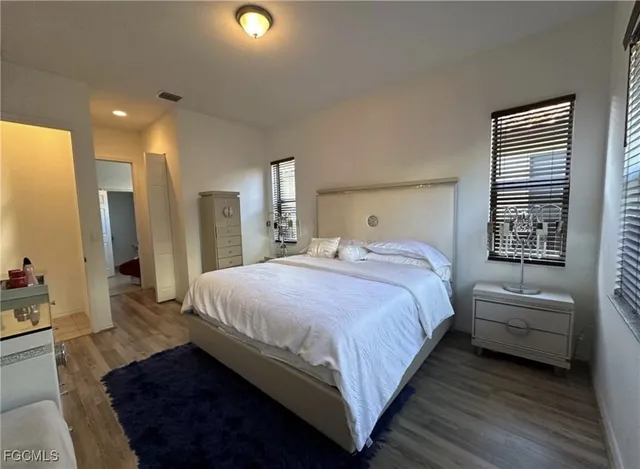 a bedroom with bed and window