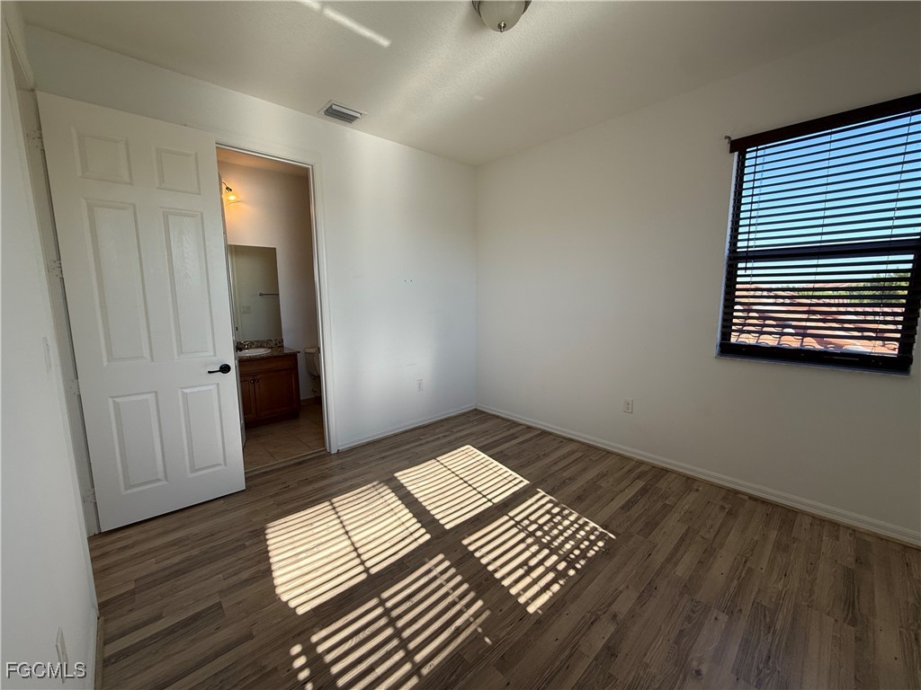 5510 Useppa Drive Ave Maria, FL 34142 - Photo 17 of 20 a view of wooden floor and windows in a room
