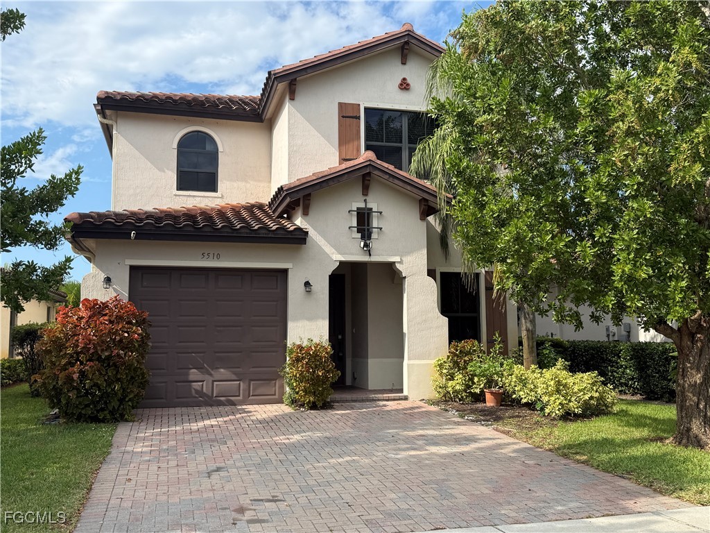 5510 Useppa Drive Ave Maria, FL 34142 - Photo 2 of 20 a front view of a house with garden