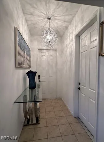 a view of a hallway with a chandelier