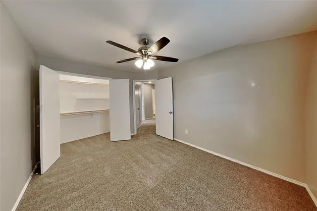 an empty room with a empty space and a ceiling fan