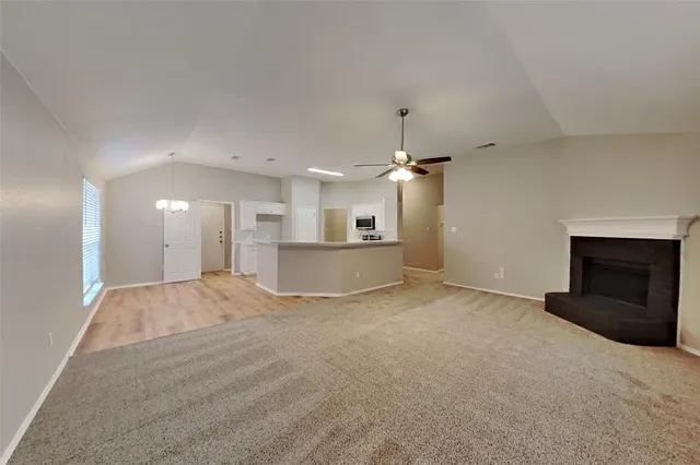 a view of a kitchen with a sink and a fireplace