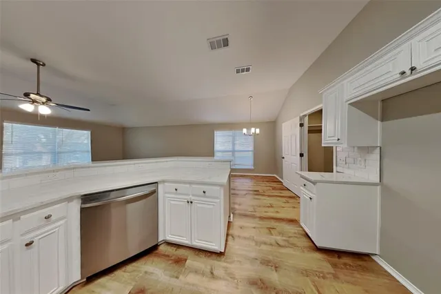 a kitchen with a sink and cabinets