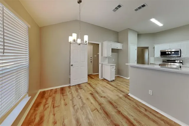 a view of a kitchen with a sink and refrigerator