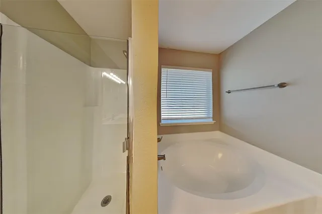 a bathroom with a bathtub and a shower