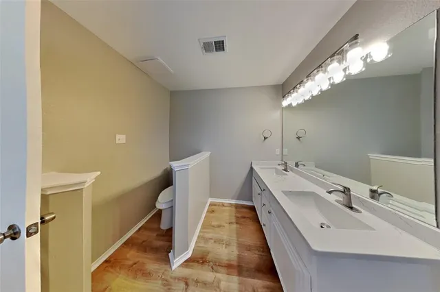 a bathroom with a double vanity sink and mirror