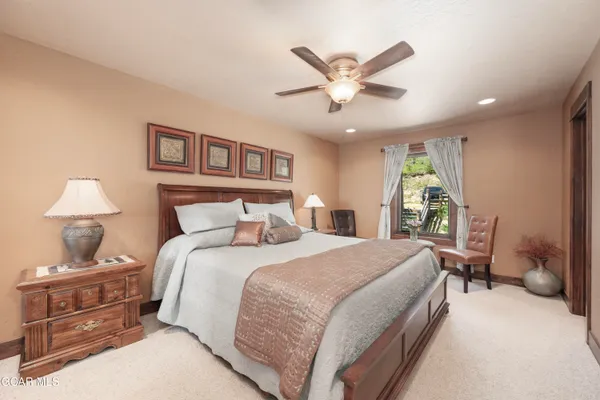 a bedroom with a large bed and a chandelier