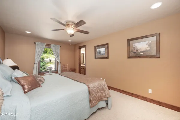 a bedroom with a large bed and a window