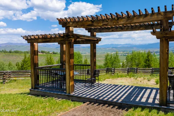 a view of swimming pool with lawn chairs and plants
