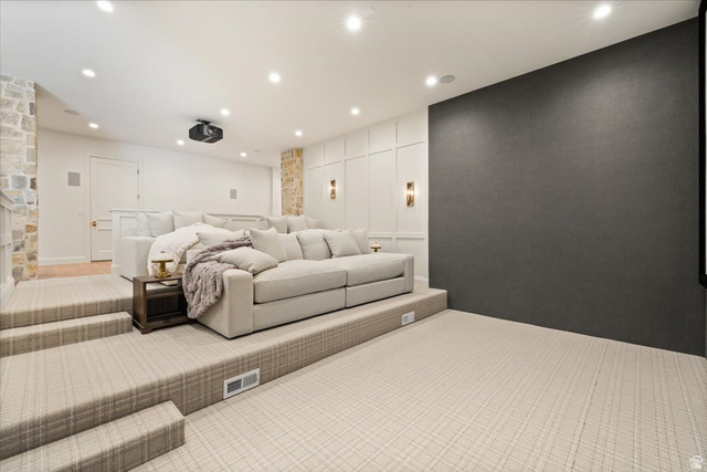478 South Maple Lakes Drive Mapleton, UT 84664 - Photo 32 of 51 Dedicated theater room featuring a large projection screen wall, multi-tiered carpeted seating, and recessed ceiling lighting