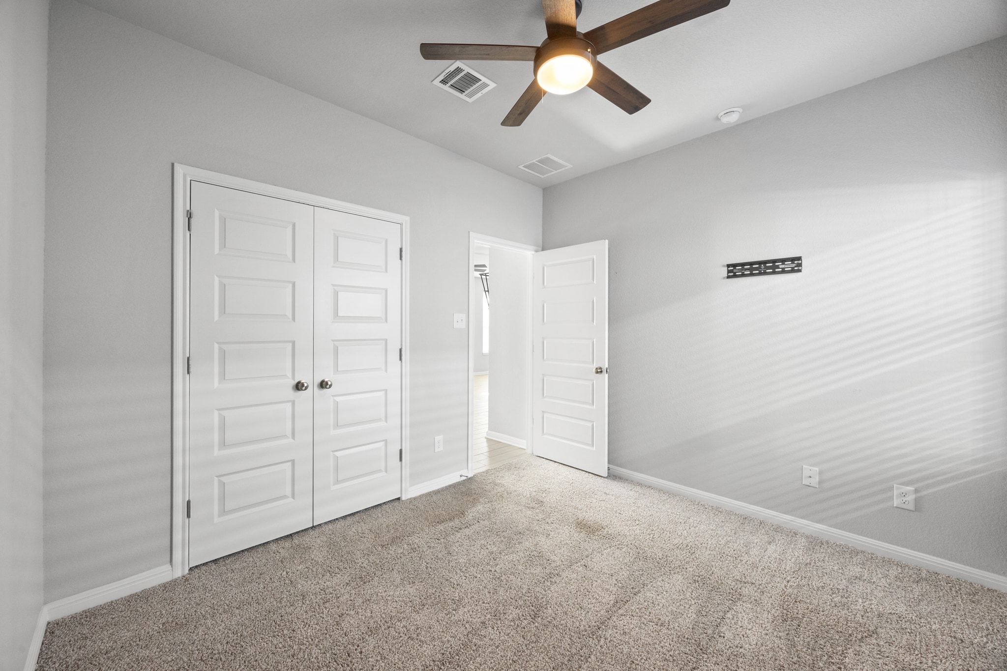 225 Unforgiven Lane Jarrell, TX 76537 - Photo 24 of 30 Unfurnished bedroom with carpet, a closet, and ceiling fan