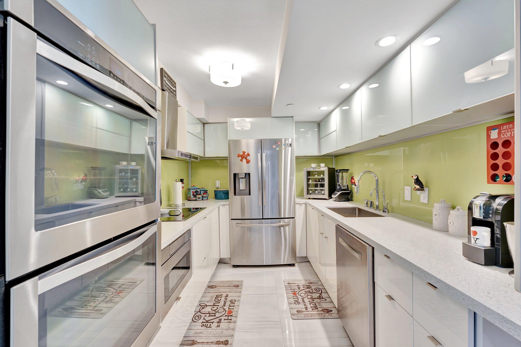 1900 South Ocean Boulevard, Unit 8G Pompano Beach, FL 33062 - Photo 2 of 54 a kitchen with stainless steel appliances granite countertop a refrigerator and a sink