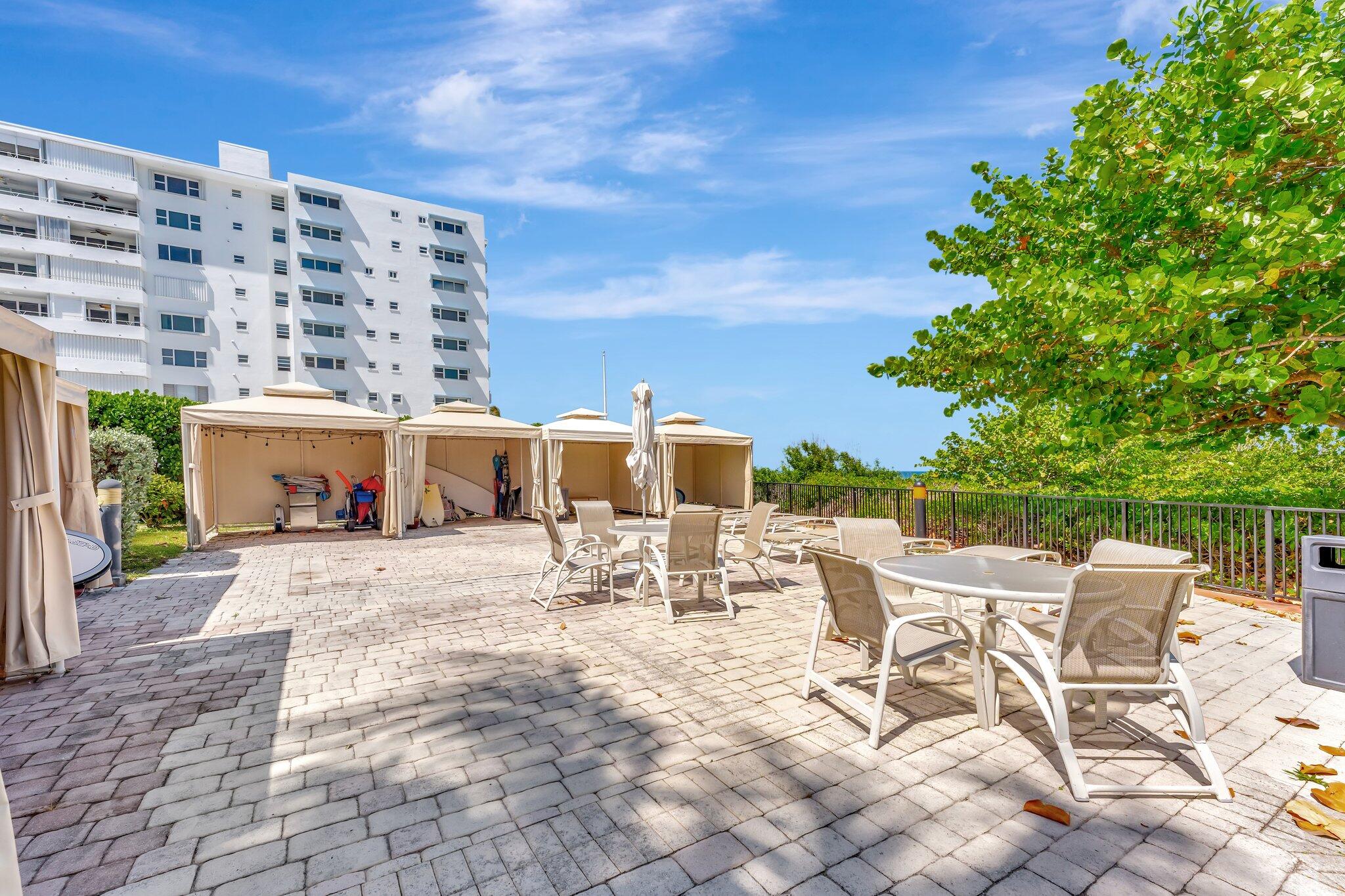 1900 South Ocean Boulevard, Unit 8G Pompano Beach, FL 33062 - Photo 31 of 54 a view of a patio with a table and chairs and potted plants