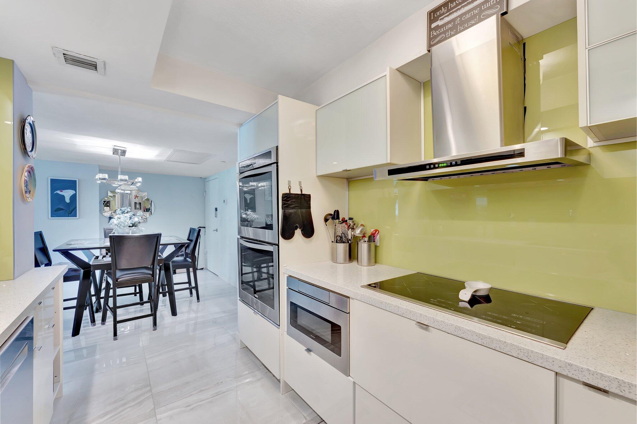 1900 South Ocean Boulevard, Unit 8G Pompano Beach, FL 33062 - Photo 5 of 54 a kitchen with a table and chairs