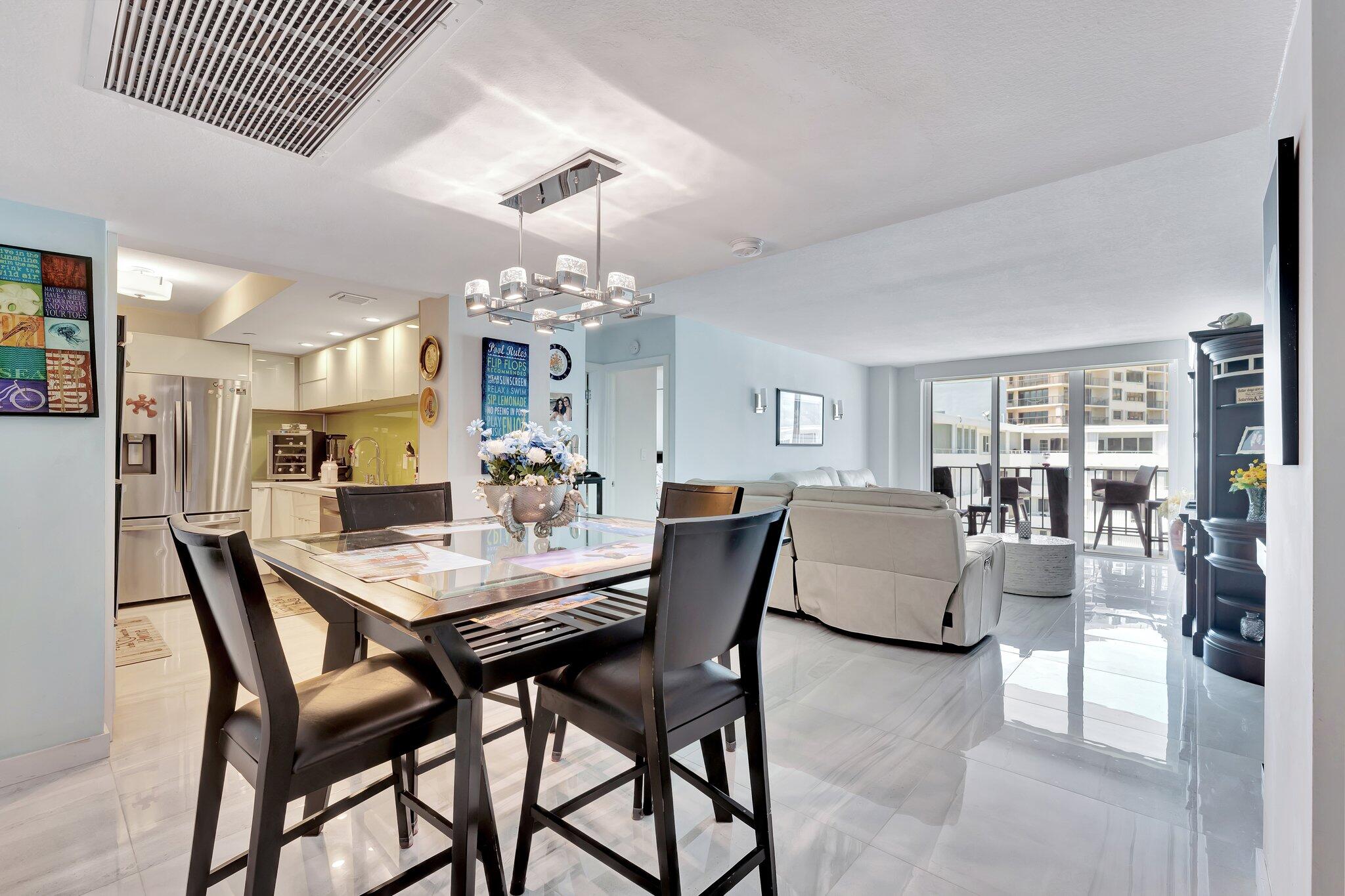 1900 South Ocean Boulevard, Unit 8G Pompano Beach, FL 33062 - Photo 8 of 54 a view of a dining room with furniture and wooden floor
