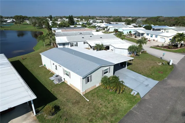 an aerial view of a house with a yard basket ball court and a basket ball court
