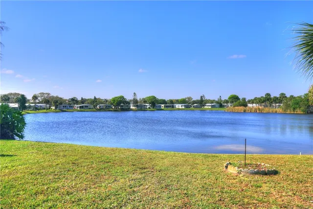 a view of a lake with houses in the back