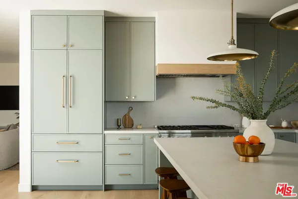 a kitchen with a sink a stove and cabinets