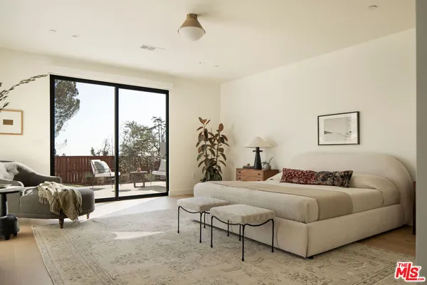 a bedroom with a bed and glass window