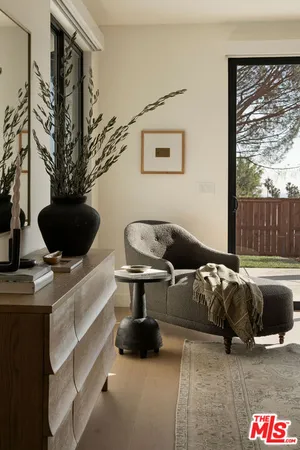 a living room with furniture and a floor to ceiling window