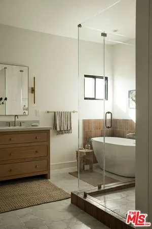 a spacious bathroom with a granite countertop sink and a mirror