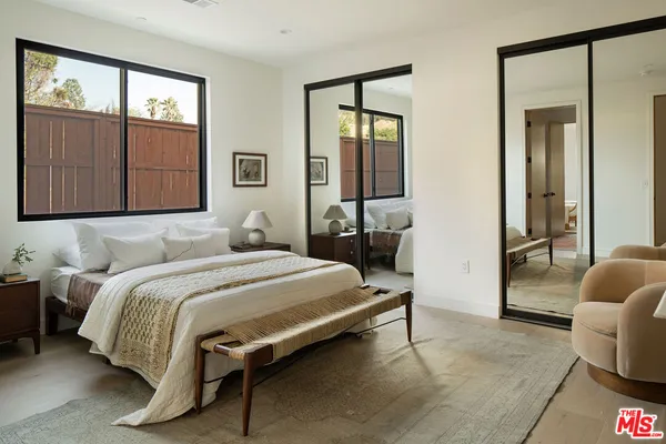 a bedroom with a bed and with large window