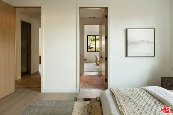 a bedroom with a bed and hallway