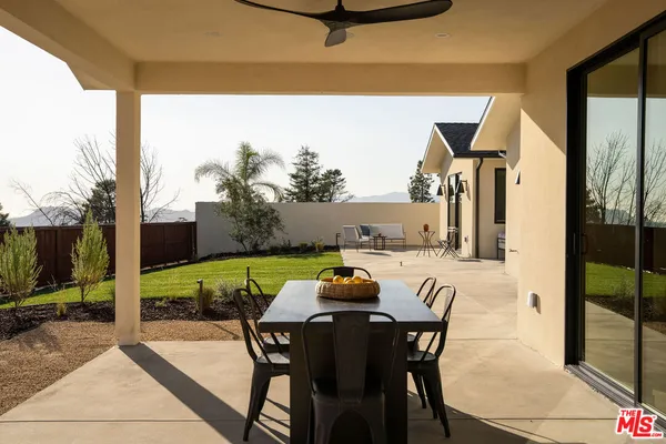 a view of an outdoor dining space with furniture