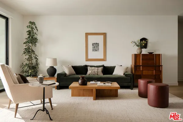a living room with furniture and flowers