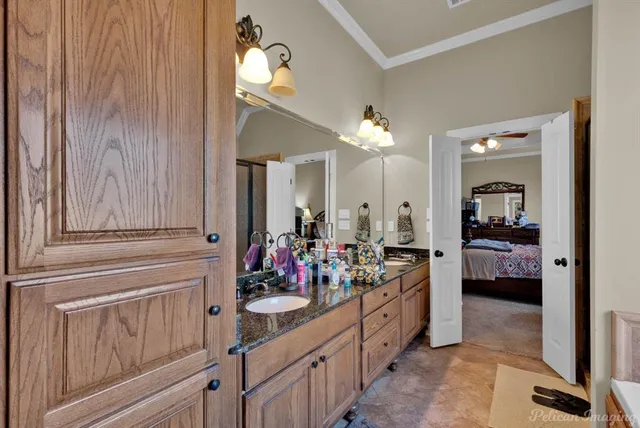a bathroom with a tub a mirror and a shower