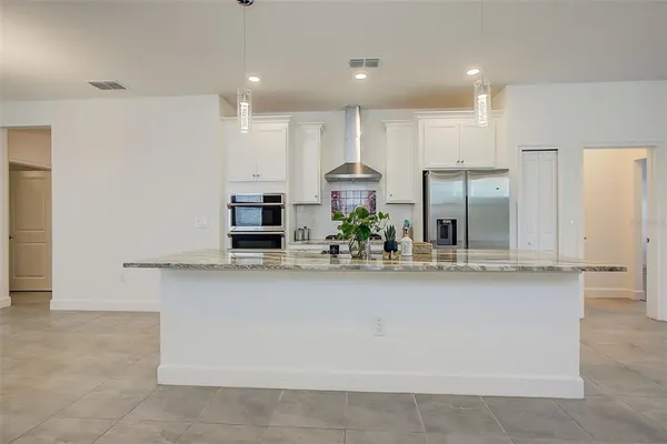 a view of a kitchen with a sink and a refrigerator