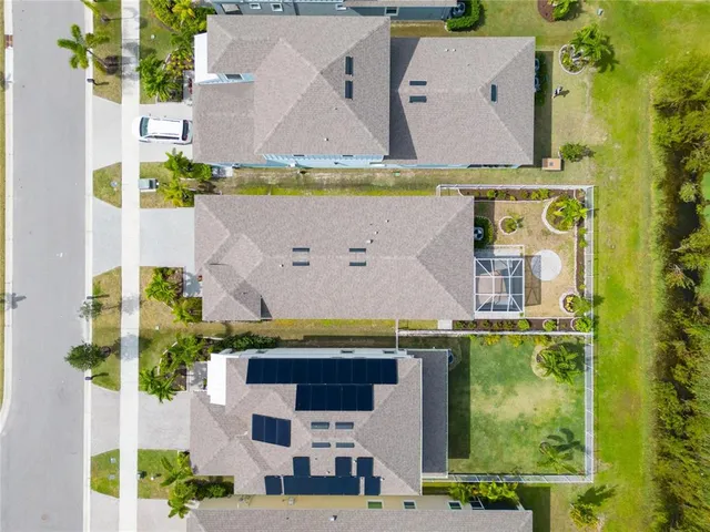 aerial view of a house with a yard and a large pool