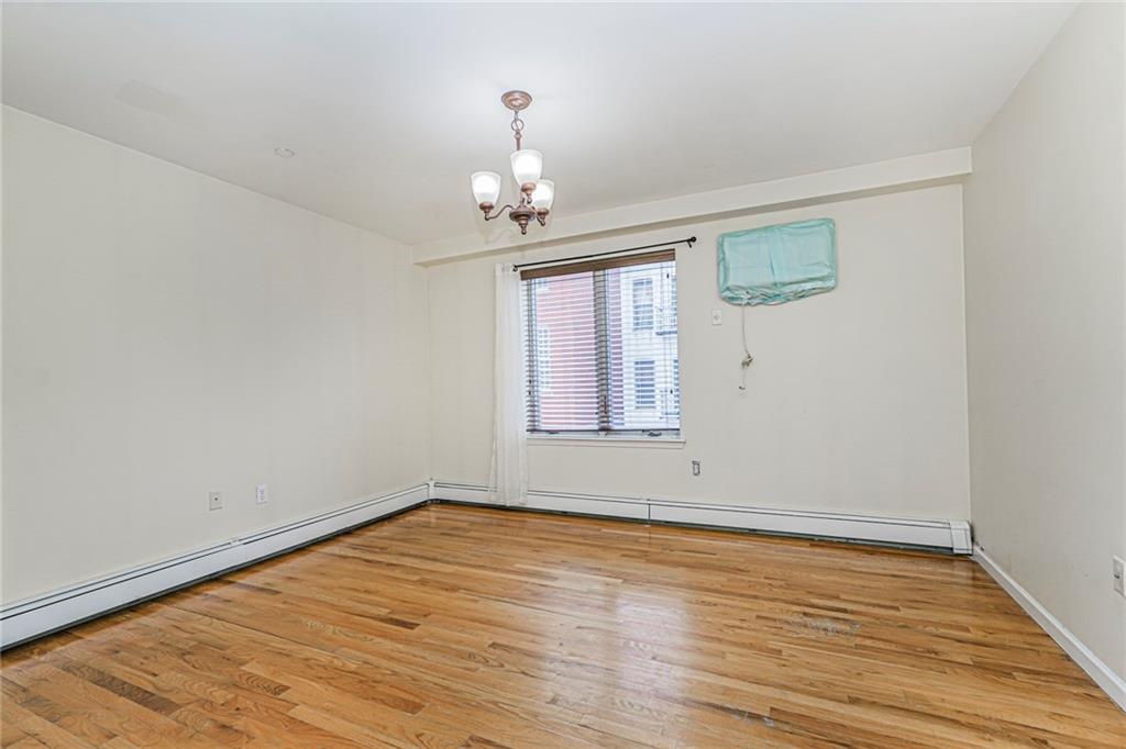 1838 West 13th Street, Unit 3B Brooklyn, NY 11223 - Photo 11 of 22 wooden floor in an empty room with a window