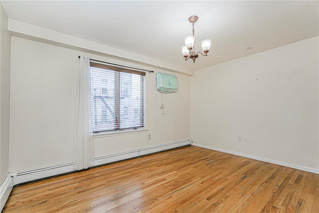 1838 West 13th Street, Unit 3B Brooklyn, NY 11223 - Photo 12 of 22 a view of empty room with wooden floor and fan