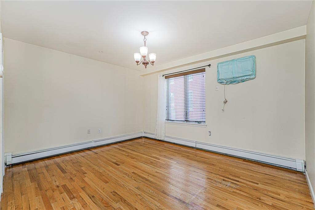 1838 West 13th Street, Unit 3B Brooklyn, NY 11223 - Photo 14 of 22 wooden floor in an empty room with a window